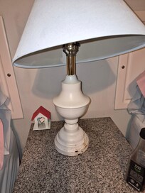 Lamp is rusted. The little house holds your extension cord.