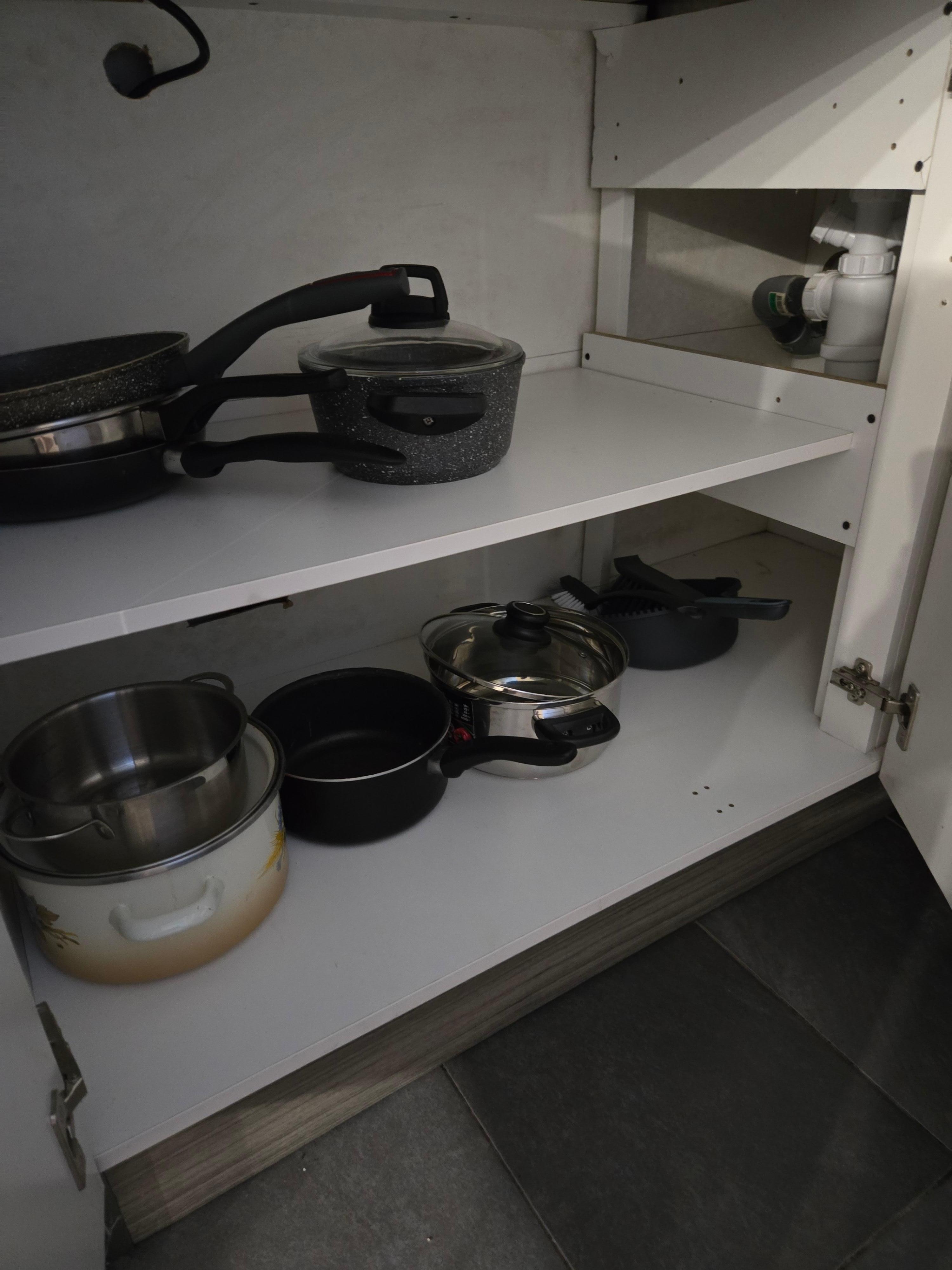 The dustpan and hand broom were next to the pots and pans, very non-hygienic!