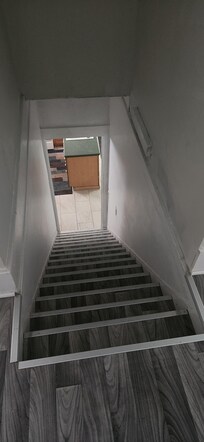 The stairs to the 3 upstairs bedrooms and bathroom