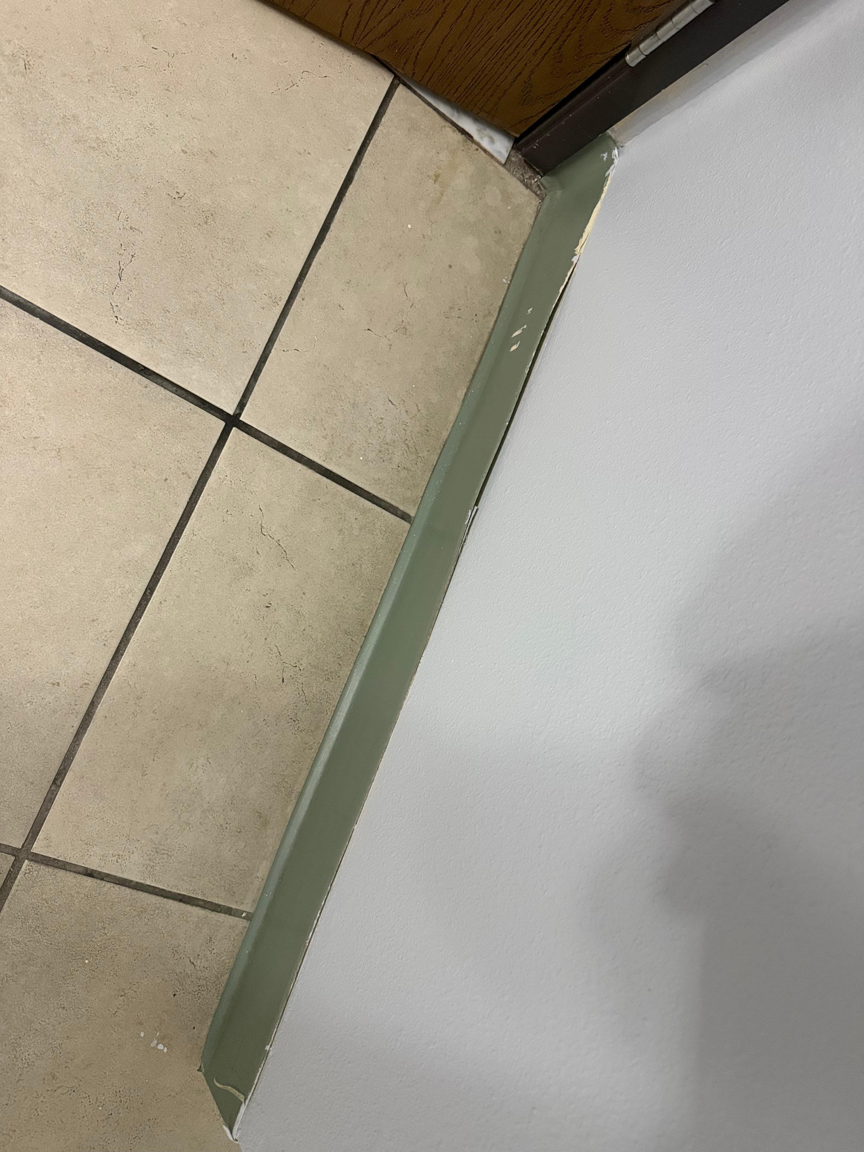 Baseboard peeling off. 