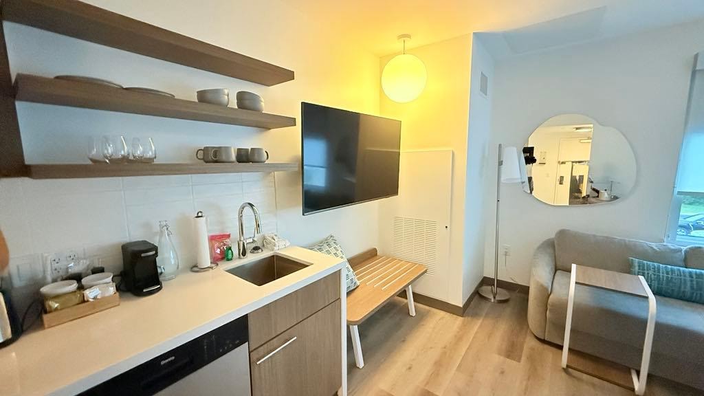 Room with full kitchen including dishwasher microwave oven and enough dishes for 4 apartment size refrigerator with freezer