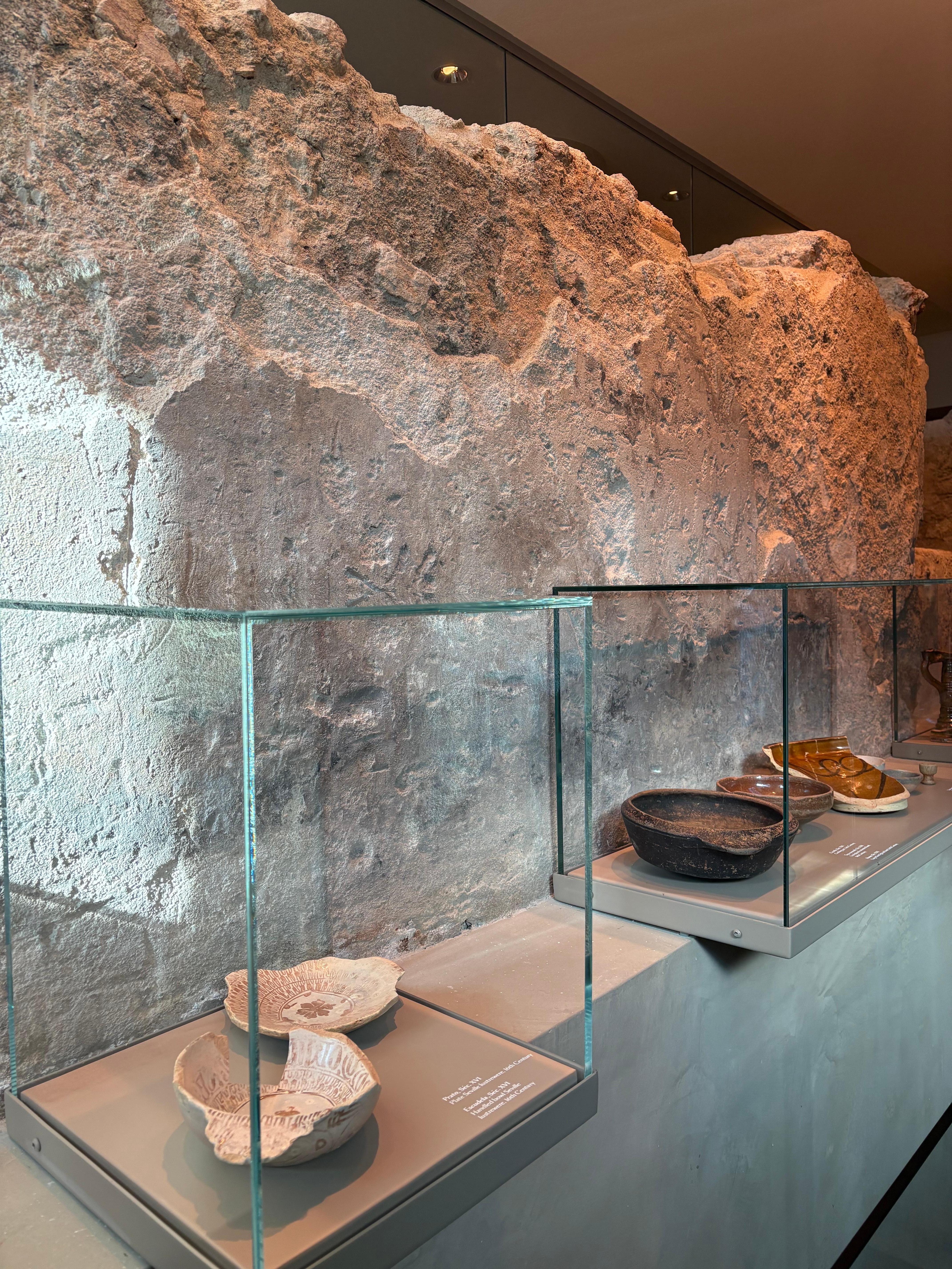 Living room area with ancient stone wall. Historical info and artifacts. Very cool!