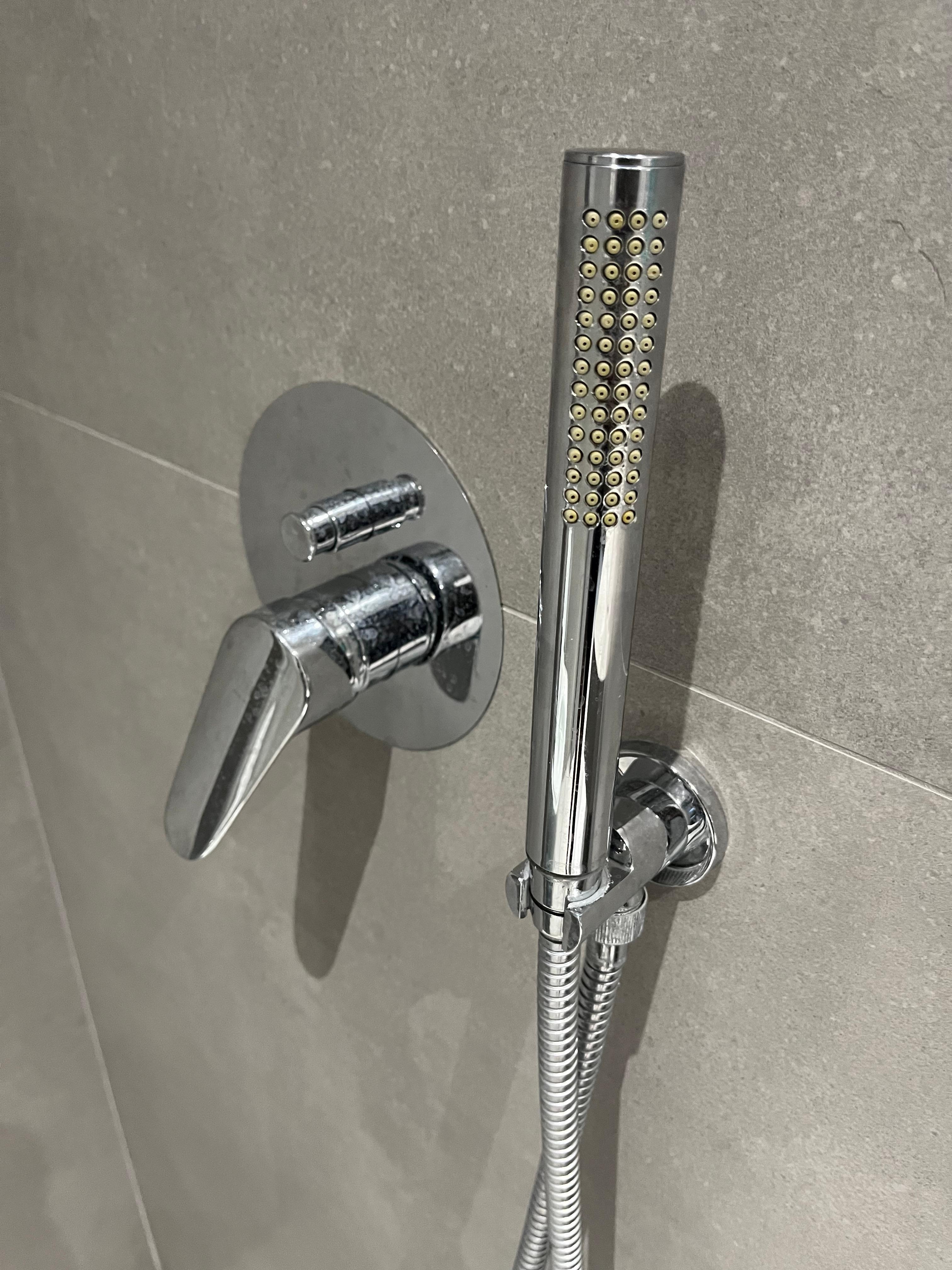 You can see the way that the shower head is facing outwards is how I met it so when I turned the tap, I expected the rainfall showerhead would fall down I didn’t even realise that the showerhead was facing me and a strong jet of water would shoot out
