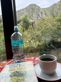 Coffee and book in the lounge overlooking the river and mountain
