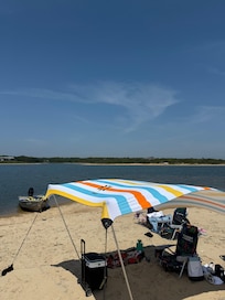 Our beach set up — we brought the canopy but they provided towels, chairs, coolers etc.