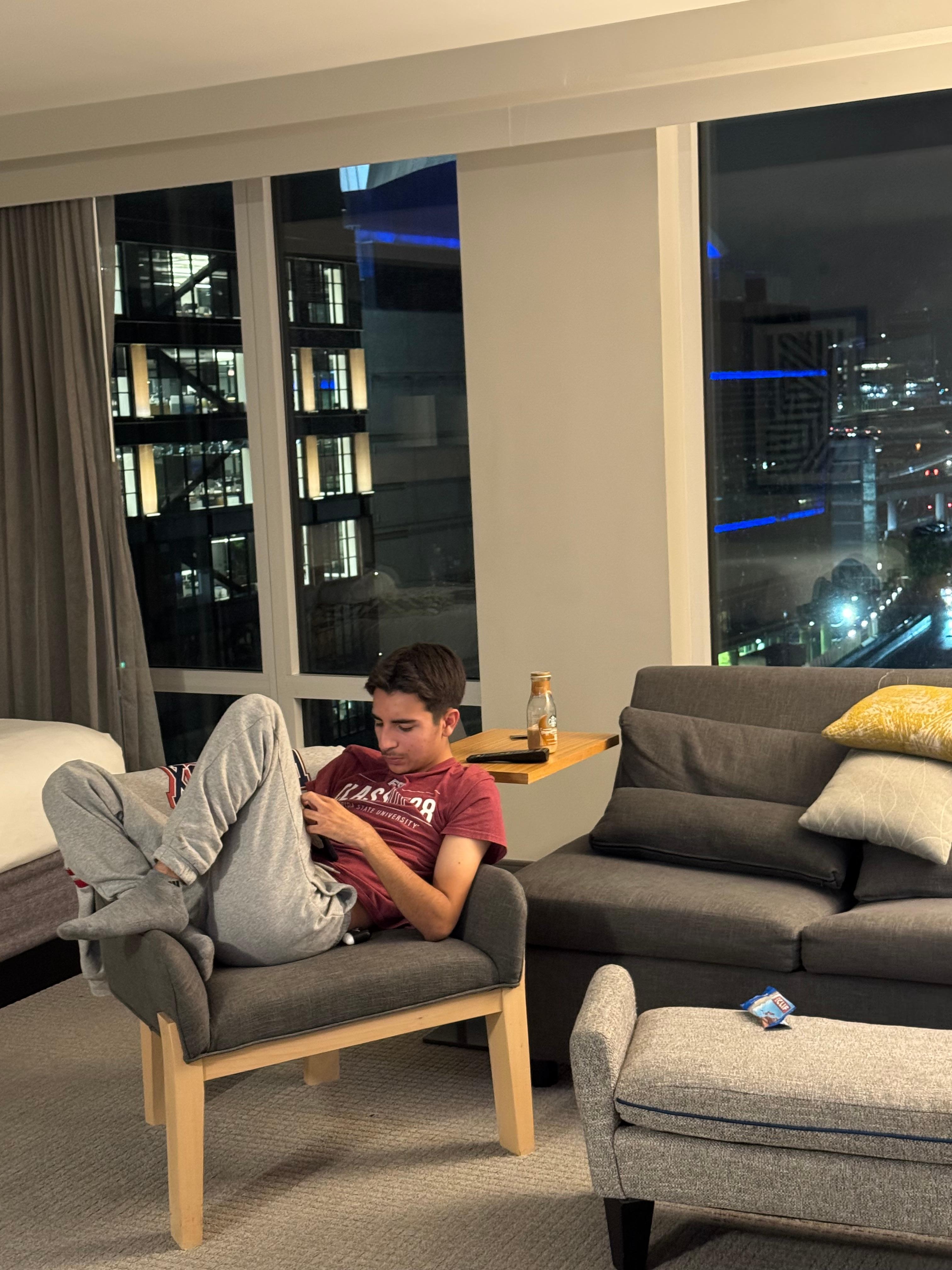 Son relaxing at night , highway in the background