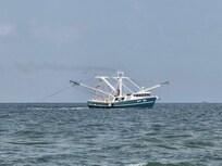 Fishing boat off the beach in front of condo