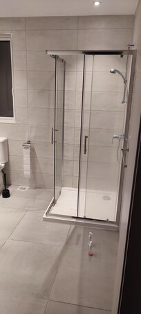 large bathroom with shower and a washing machine