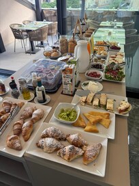 Breakfast (coffee, bread and cold meats/cheese on another table)