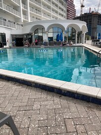 The pool was nice with outside bar for drinks and food .