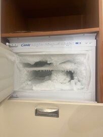 We had to chip away ice in the freezer just to fit a bottle of wine.