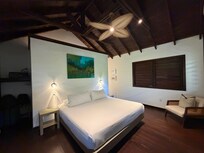 Sea View Suite interior, Caribbean charm with wood detail and shutters.