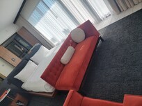 The view opposite the foyer entrance looking at the king bed, the floor-to-ceiling windows/balcony, and the bathroom beyond.