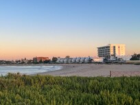 Hotel in the distance, on a sunset walk after dinner along the beachfront. There is direct beach access from the pool area at the back of the hotel.