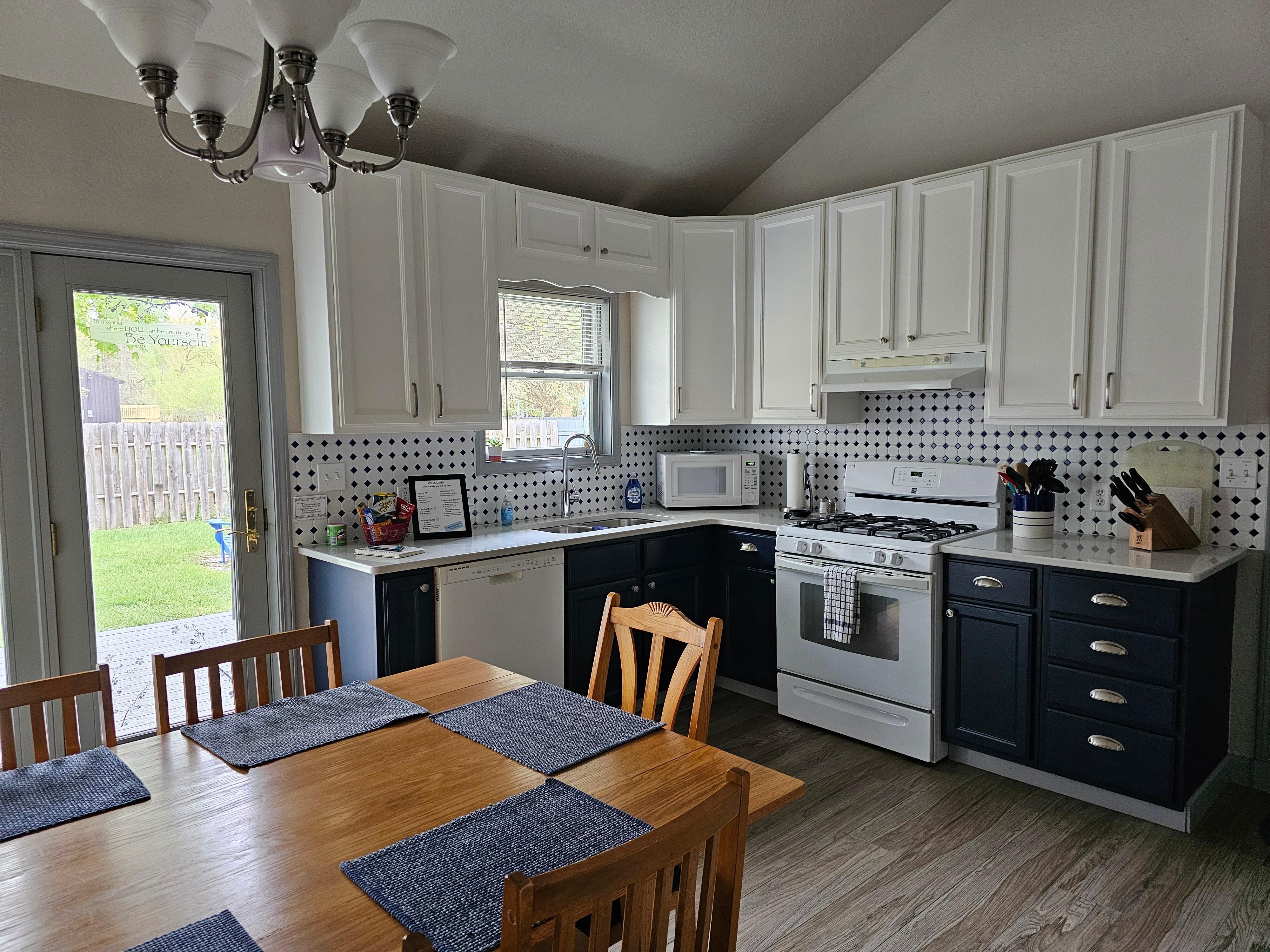 Full kitchen with gas stove, dishwasher and dining table