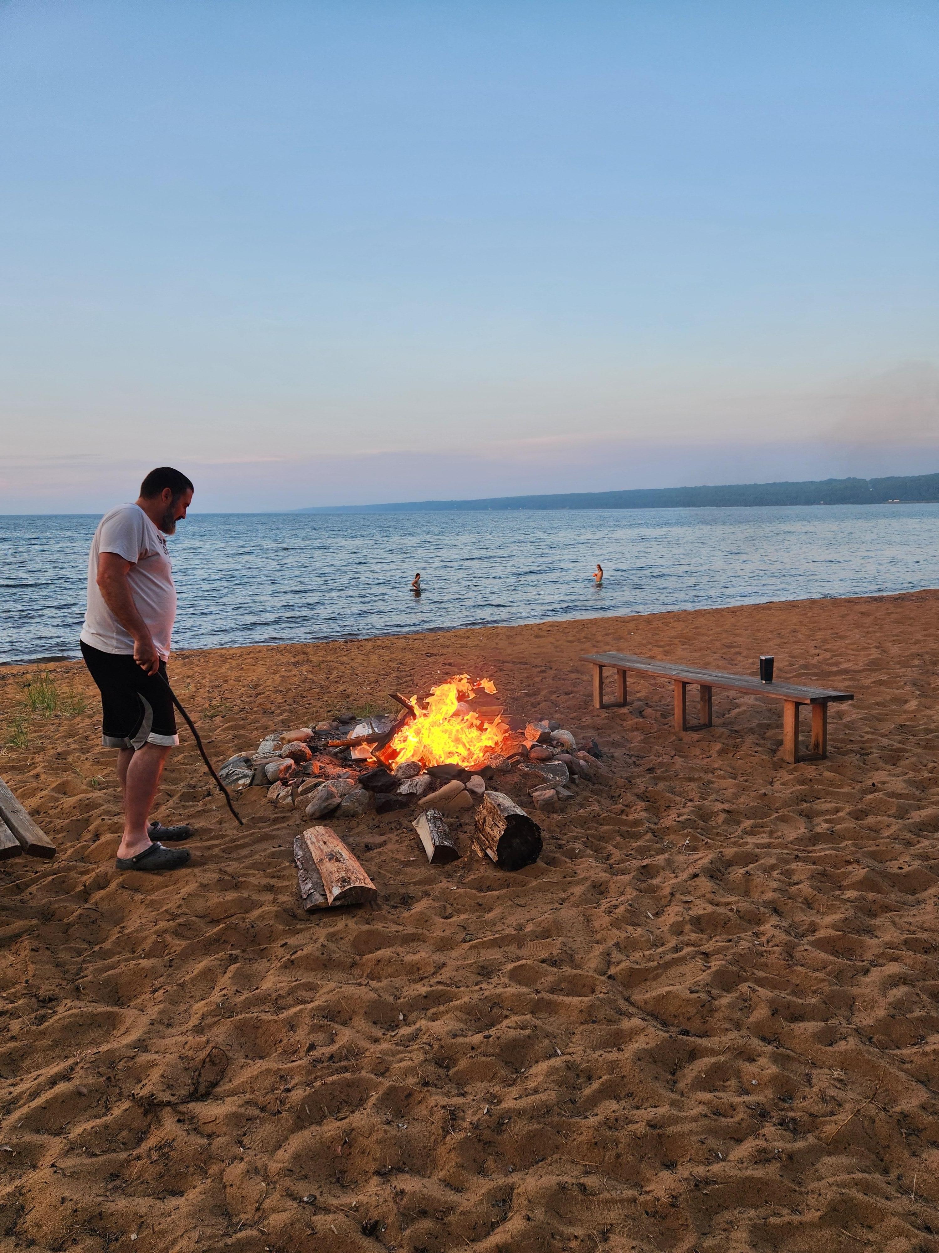 Swimming while prepping a campfire
