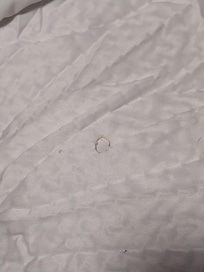 Old cigarette burn hole on comforter of 2nd night room.