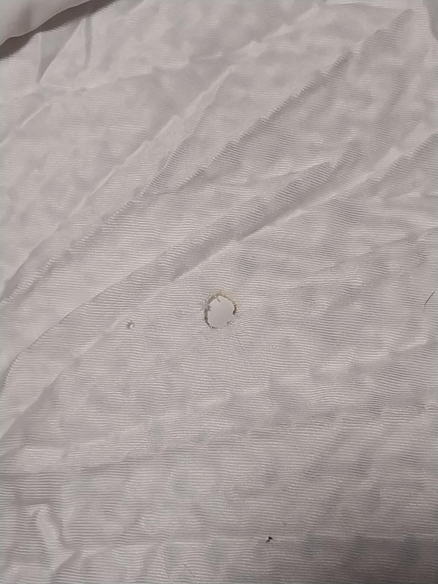 Old cigarette burn hole on comforter of 2nd night room.