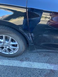 My damaged car. Clearly parked in space but someone hit and left no notes