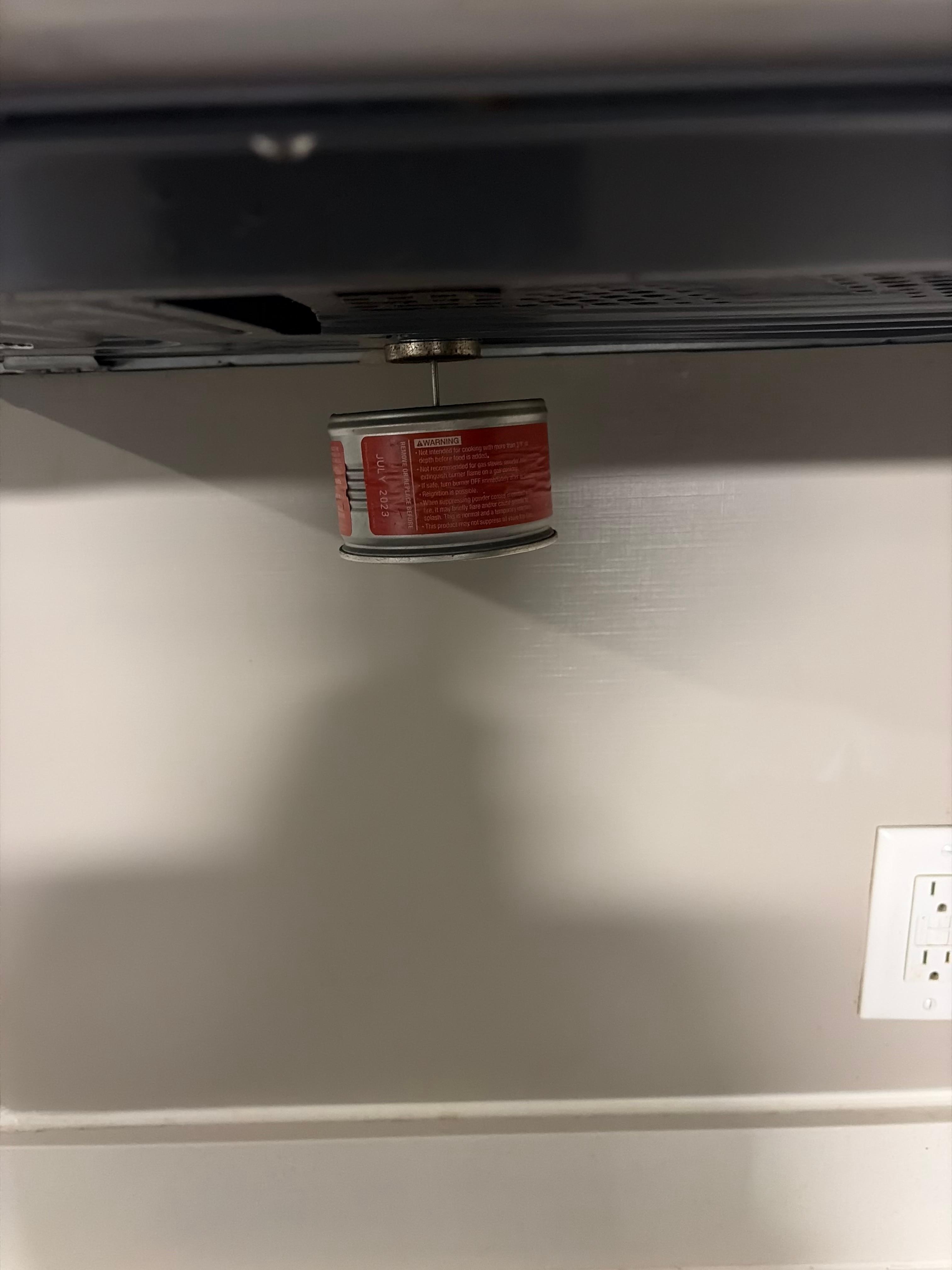 Not sure what this was hanging underneath the microwave 