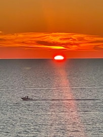 What a relaxing way to spend the evening out on a large balcony watching the sunset!