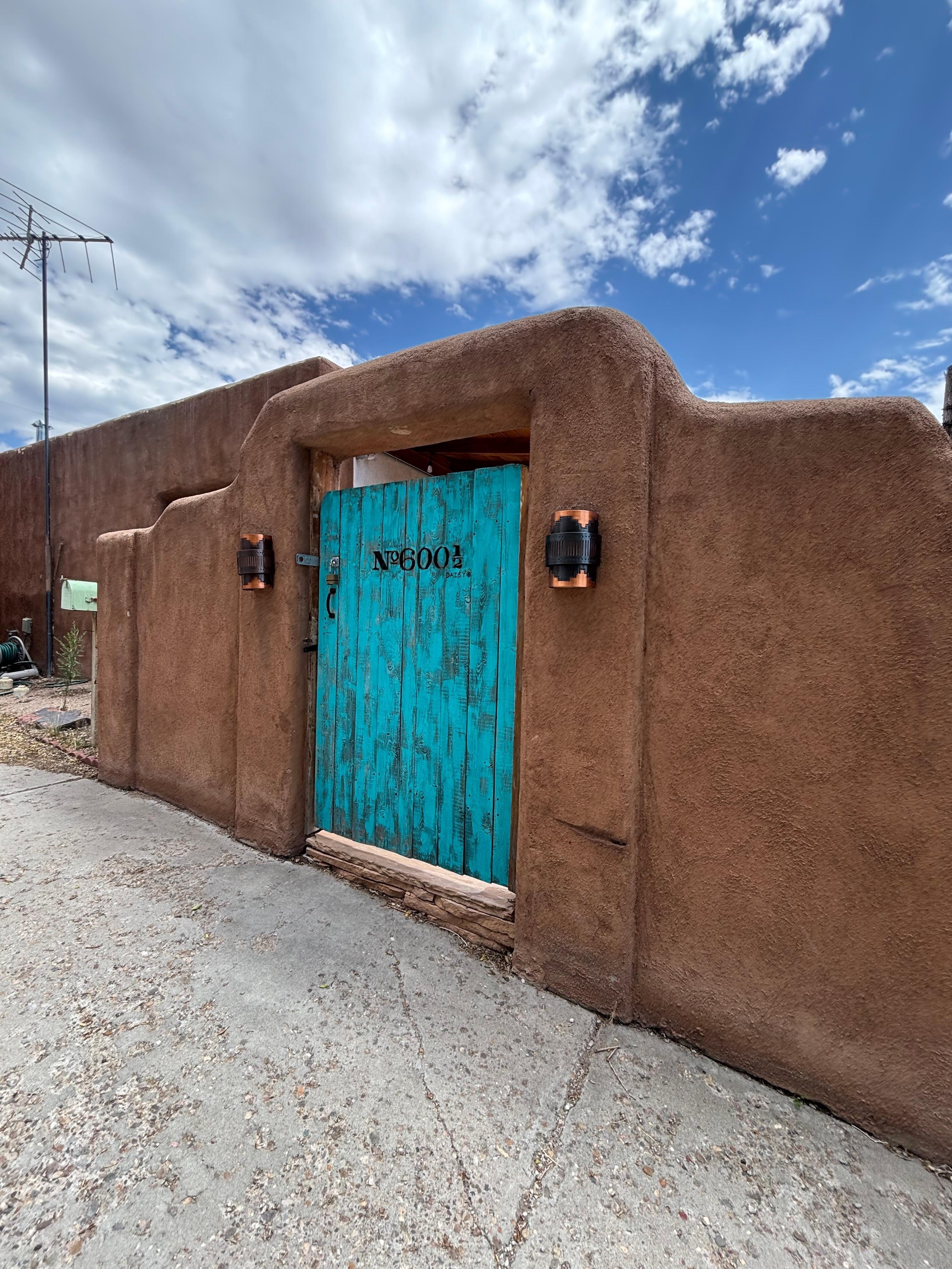 The front courtyard is large and welcoming, complete with firepit and grill. 