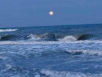 Moon rising over the surf from the deck