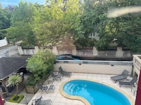 View from our room of the pool and side yard. In street parking just outside the wall