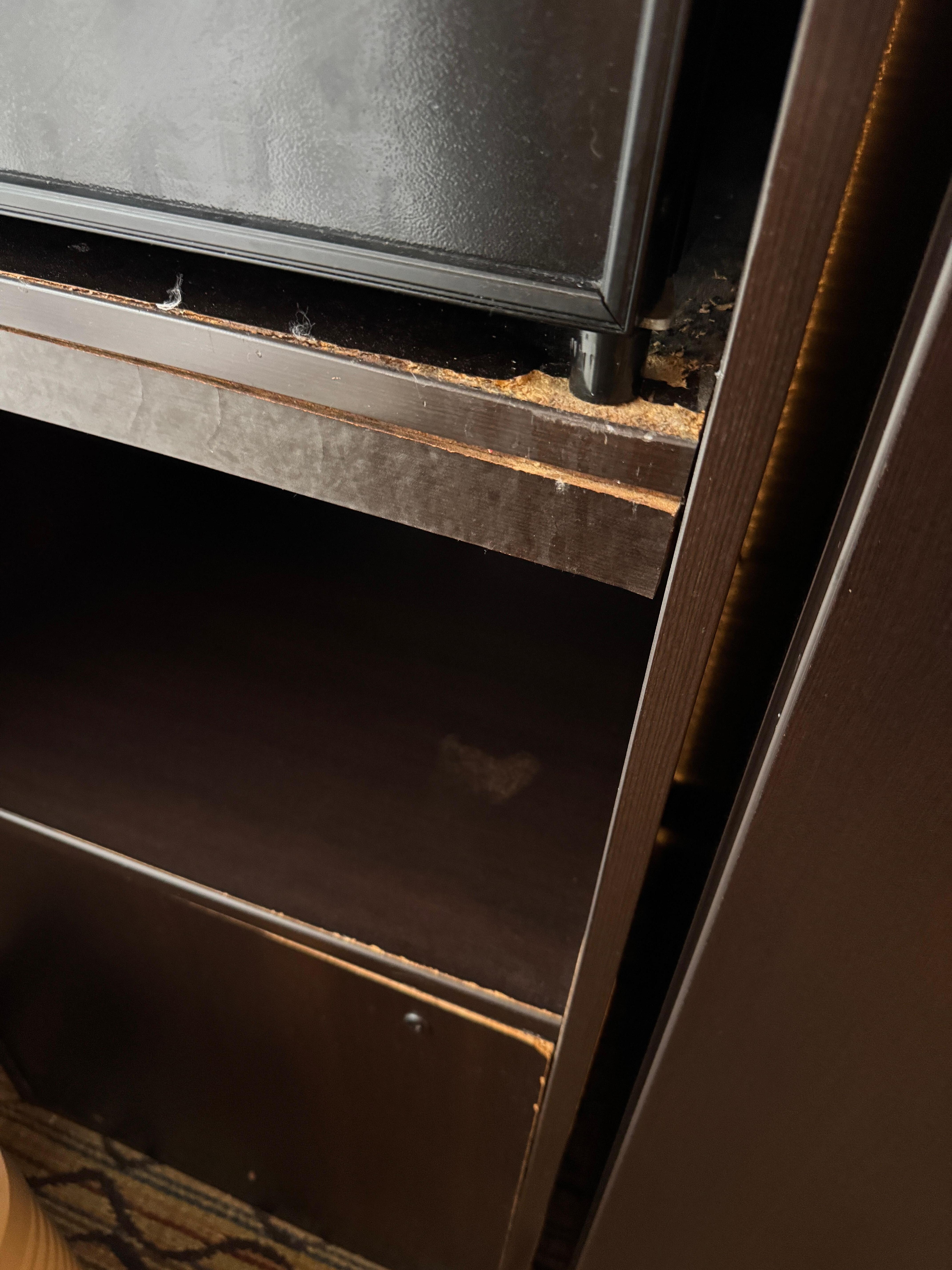 Water damage on the wood around the fridge