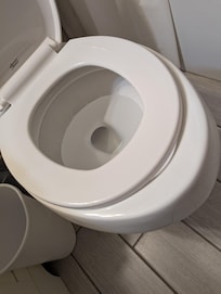 The wrong size toilet seat in one of the upsairs bathrooms