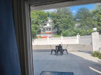 Antique wavy glass windows with view of another historic manor across the street