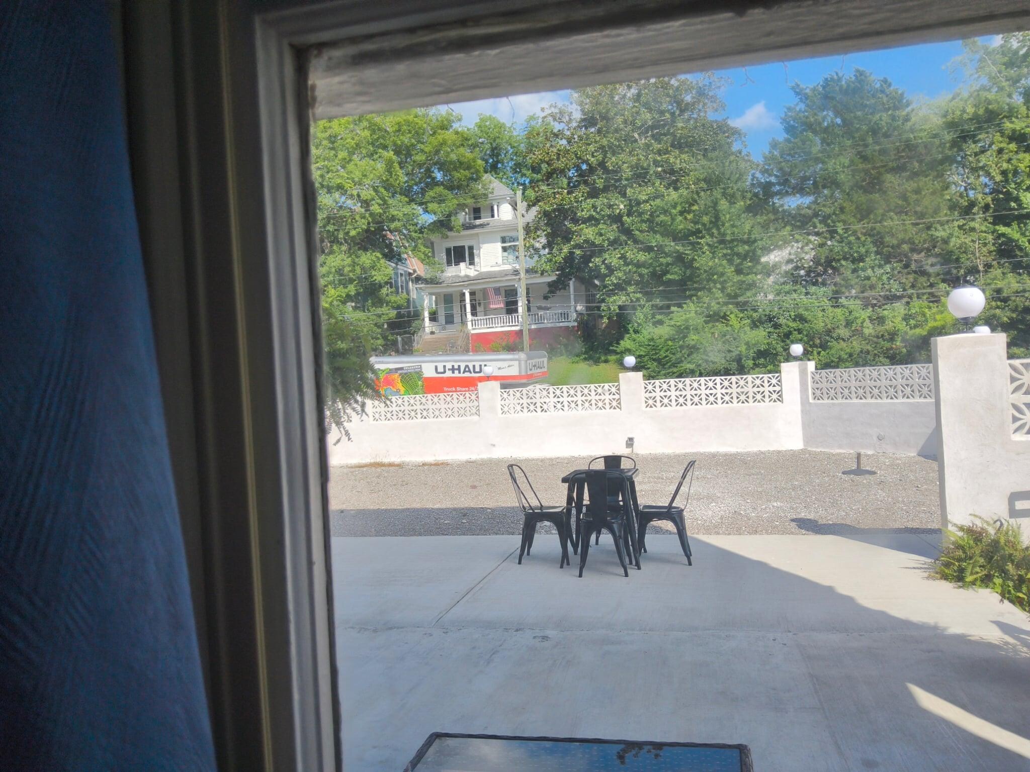 Antique wavy glass windows with view of another historic manor across the street 