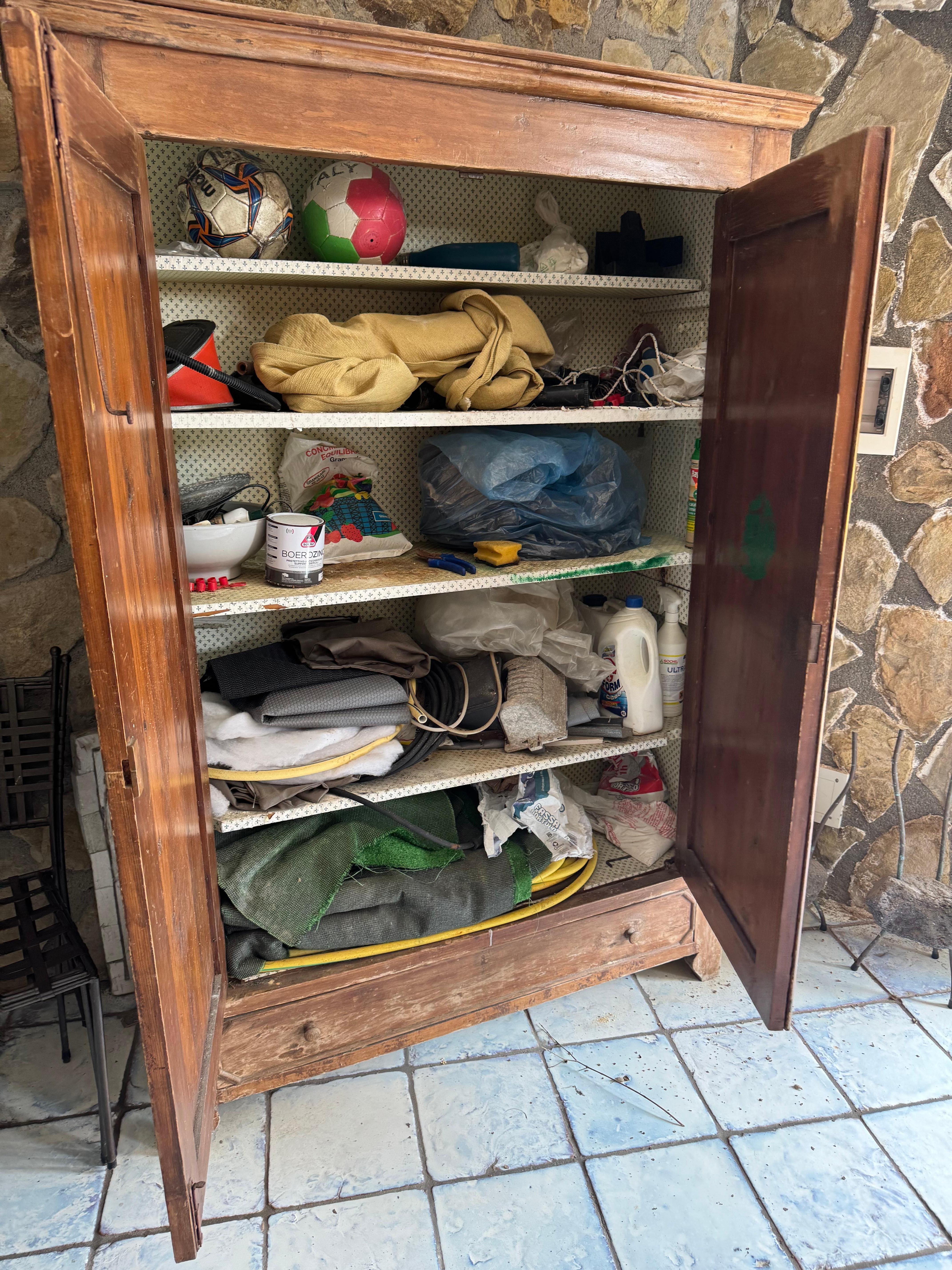 Clutter, trash, and unkept outdoor kitchen area