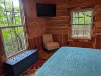 Exterior side and front area surrounded by mountain laurel. This is from the bedroom.