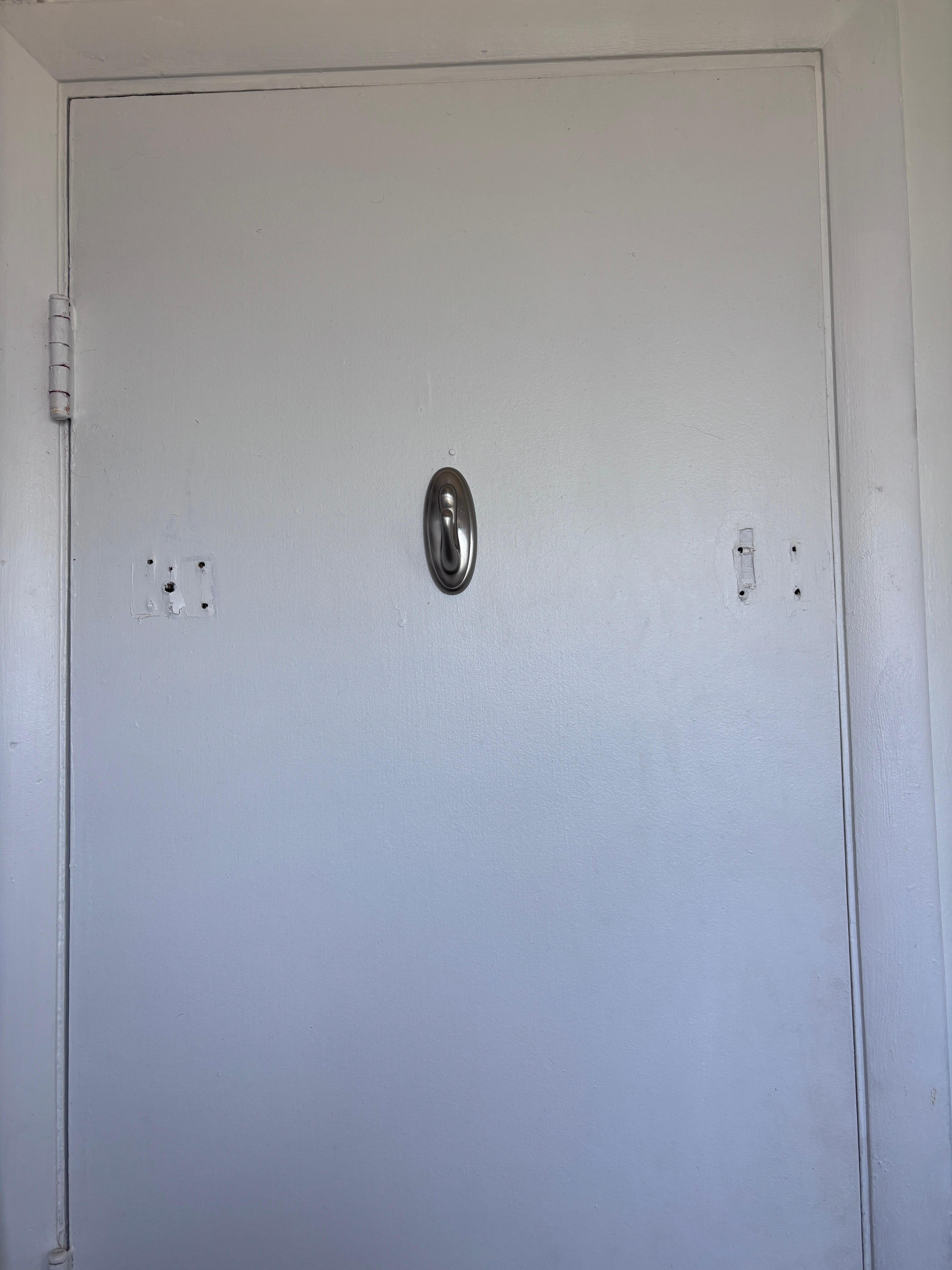 Holes in doors and painted over hinges.   Next room had tape on floor of tub/shower. 