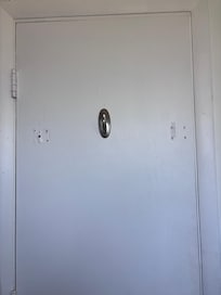 Holes in doors and painted over hinges. Next room had tape on floor of tub/shower.