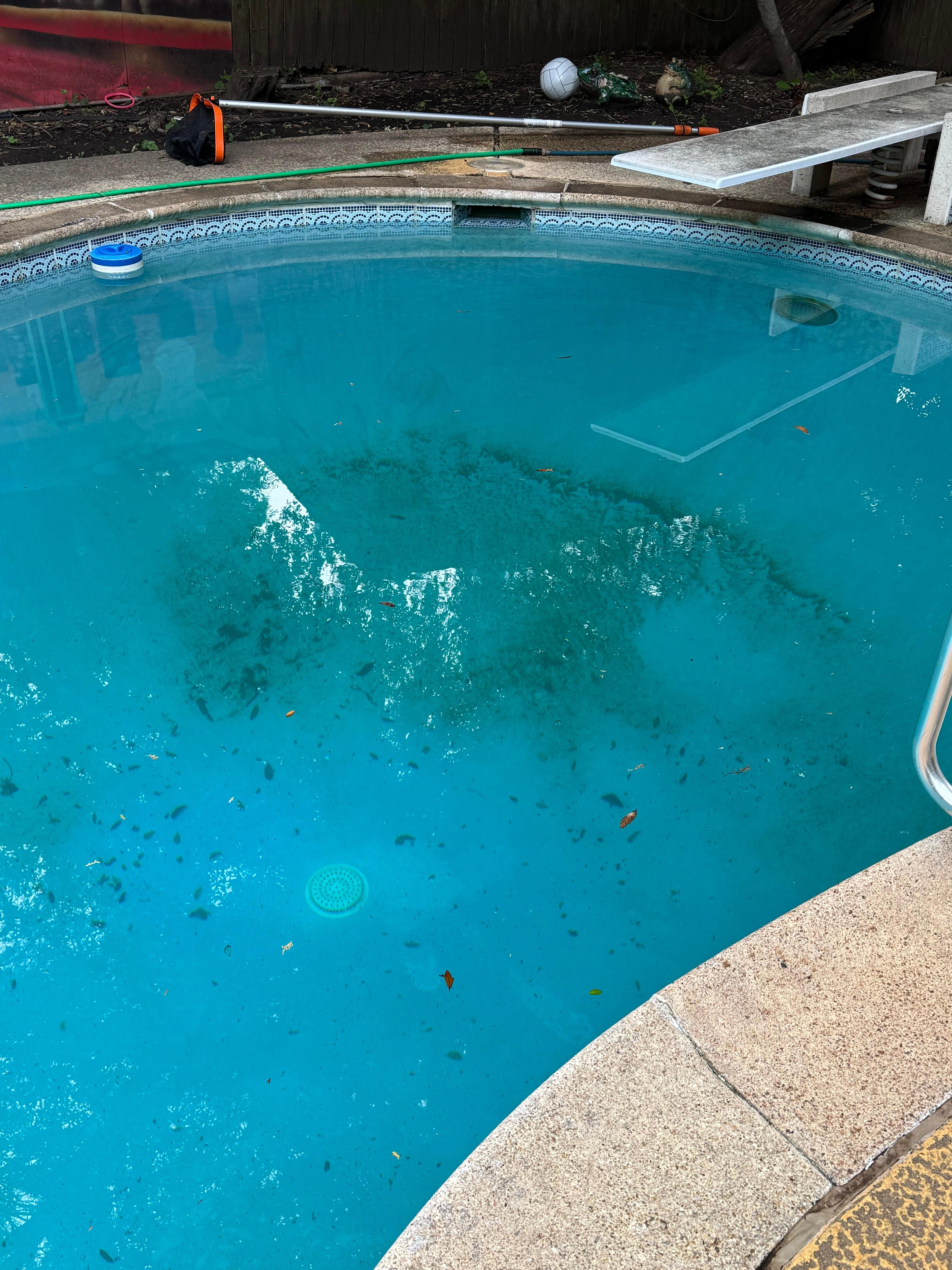Pool after we cleaned the debris with nets and before pool cleaner  came