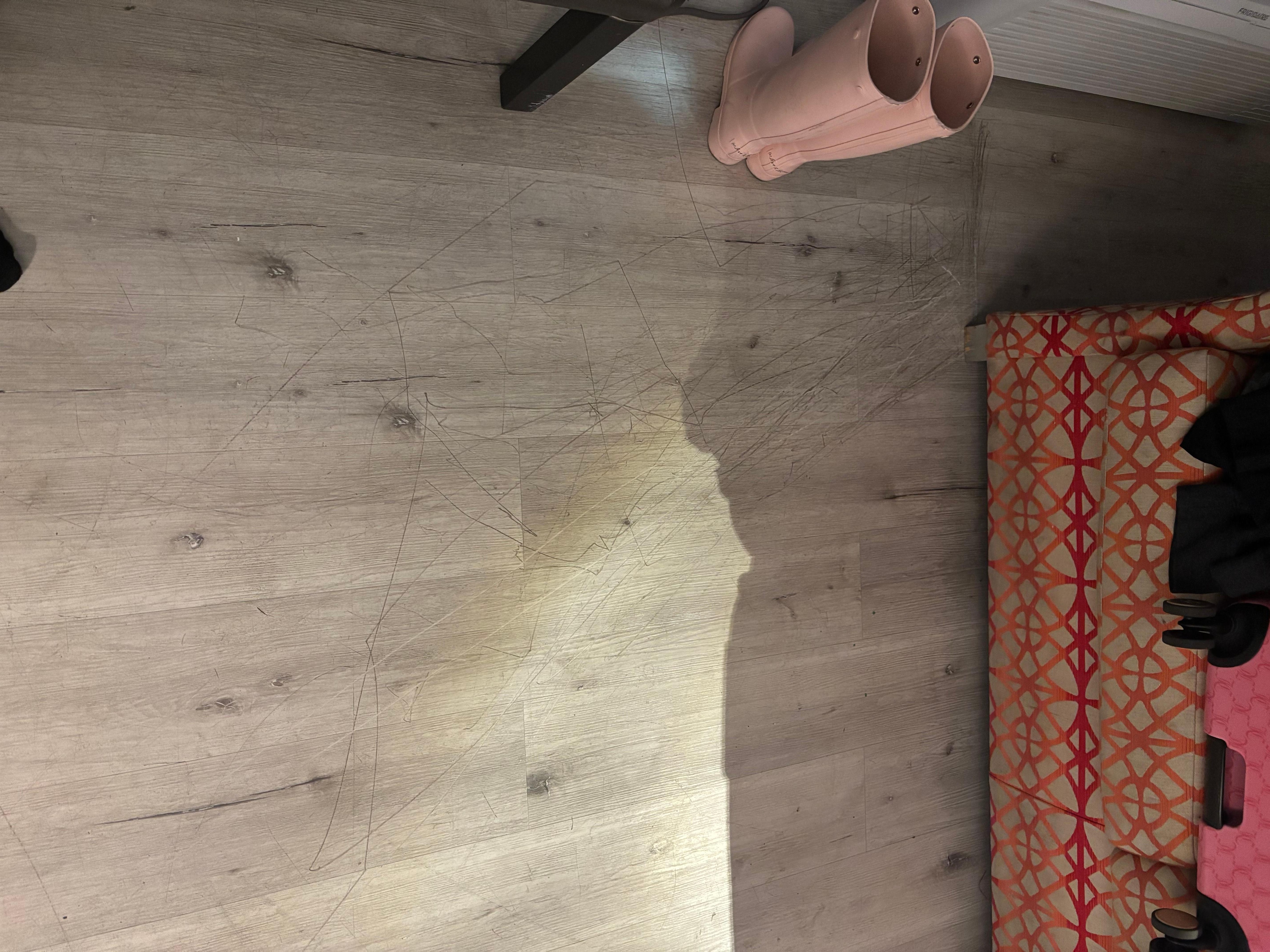 Insane amount of scratches on floor. I’m assuming it’s from the couch pulling in and out, but the whole area needs to be redone