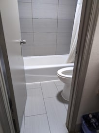 Bathroom without grab bars in room advertised as accessible. And grout looking moldy