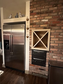 Brick kitchen wall with built-in wine holder.