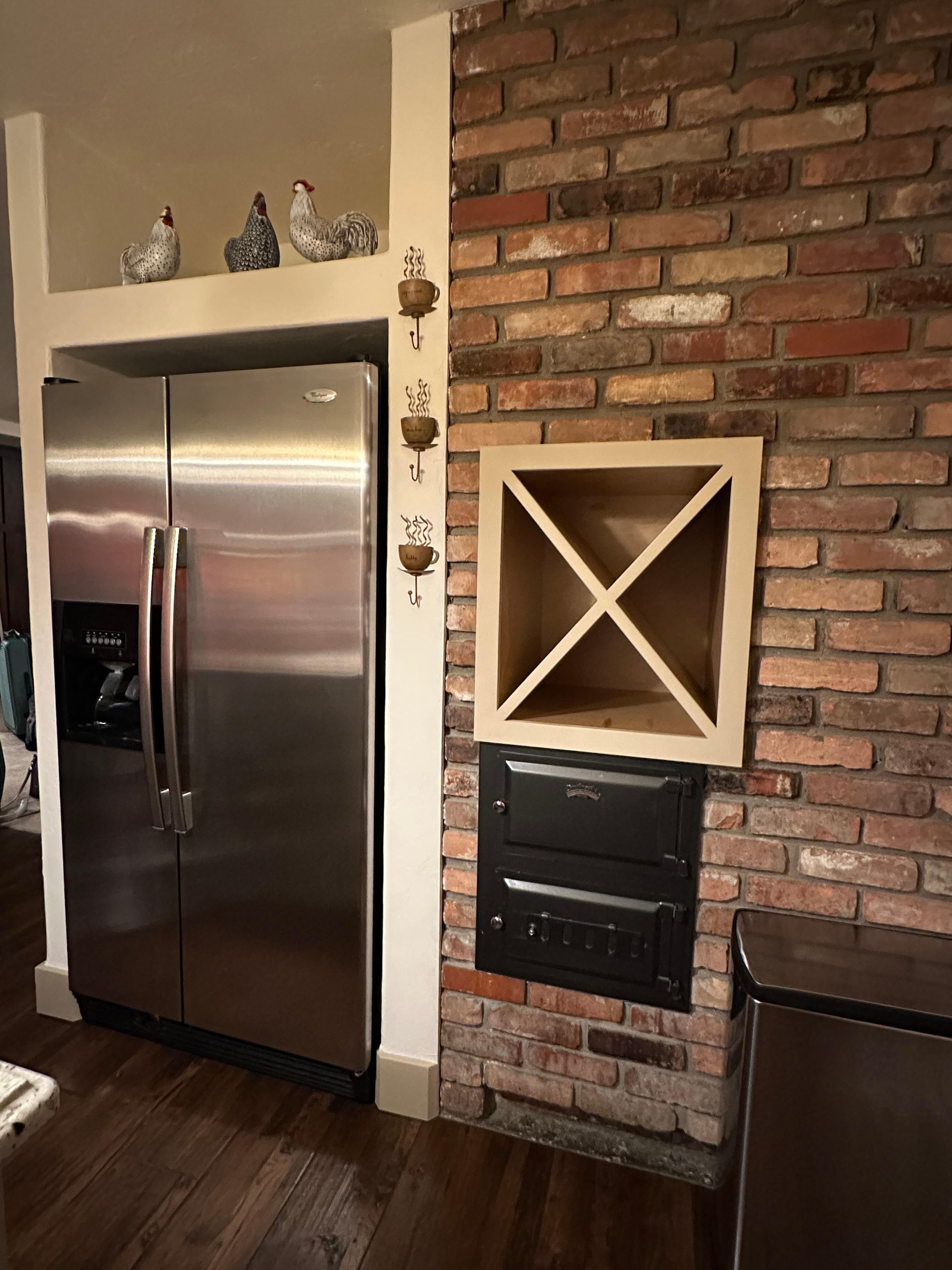 Brick kitchen wall with built-in wine holder. 