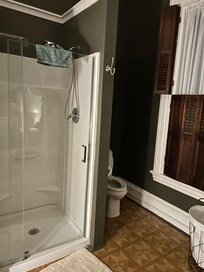 Bathroom with a very small shower.
