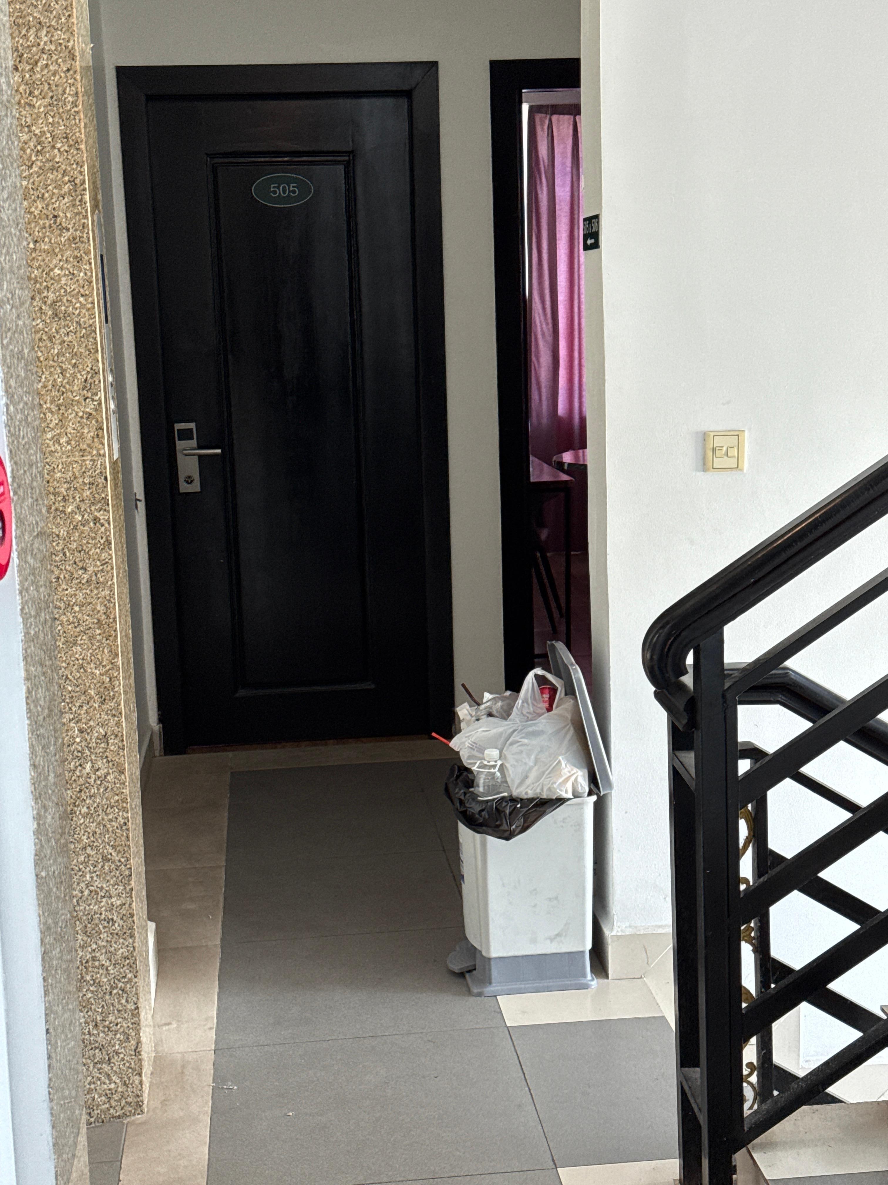 Overflowing garbage in hallway.