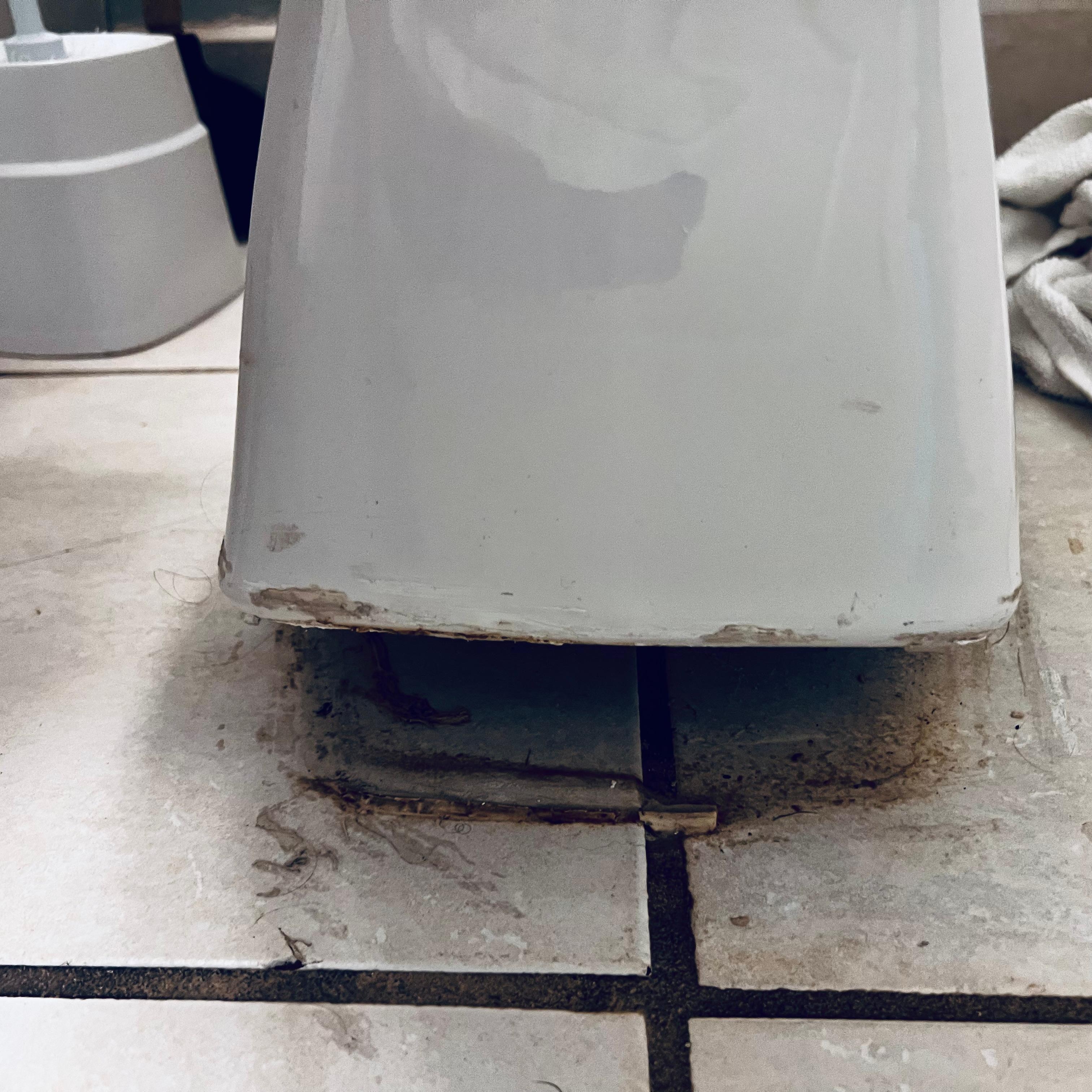 Toilet not connected and lifting off floor causing bad smell throughout condo.