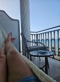 In hammock reading book in the morning.