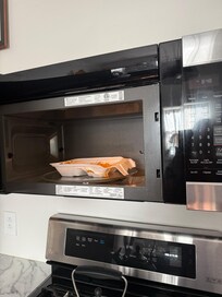 Melted styrofoam container in microwave with molded food
