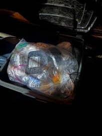 Overflowing trash cans outside of home