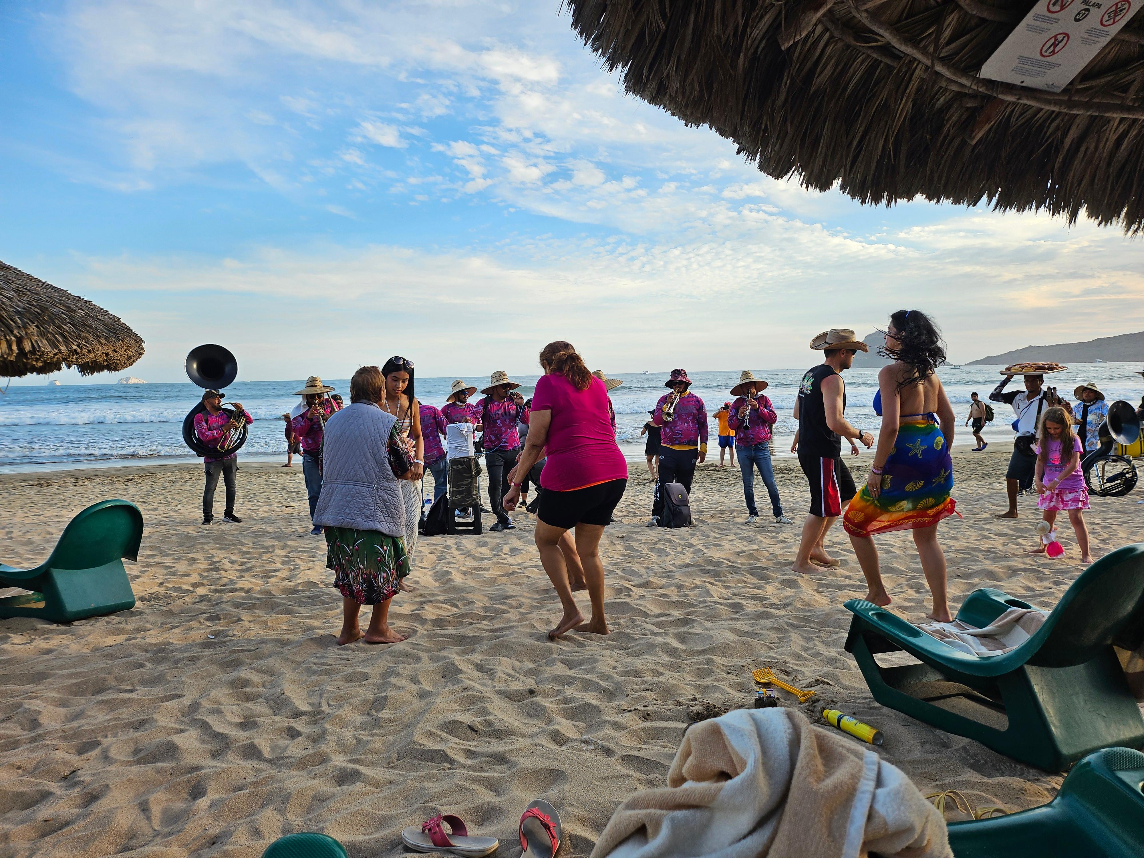 Banda music for hire on the beach, public dancing on the beach.