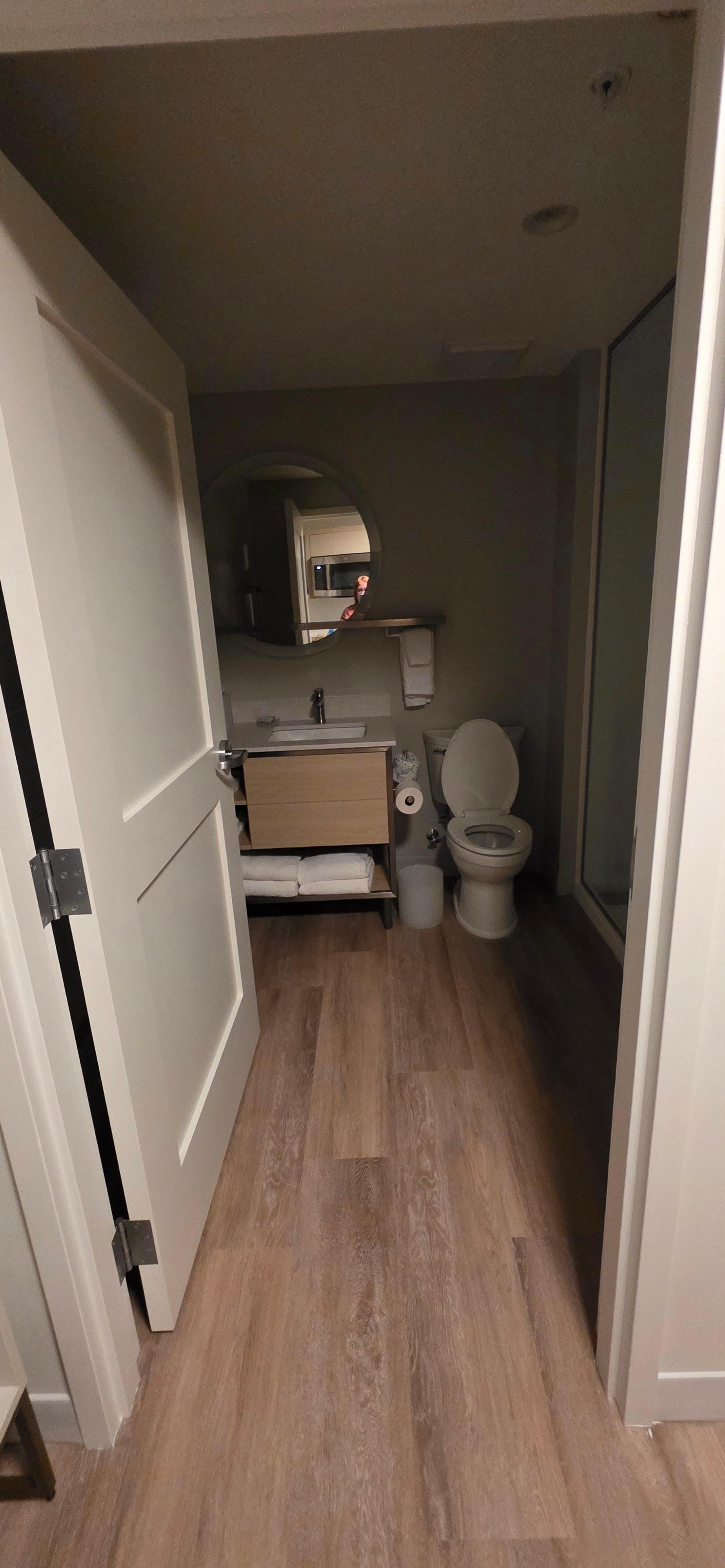 Bathroom with walk in shower, hair dryer, plenty of fresh towels
