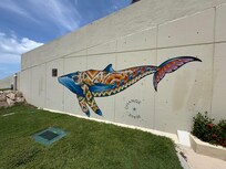 Artwork on one of the walls surrounding the resort by the beach.